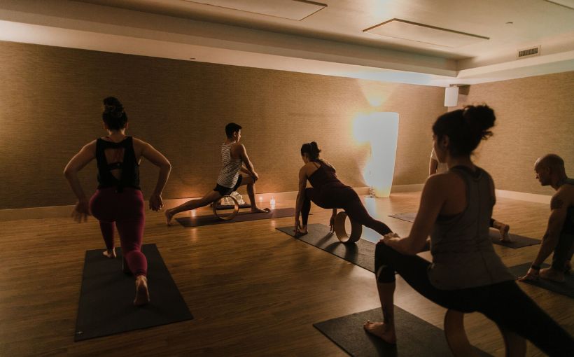 Photo of people doing yoga exercises.