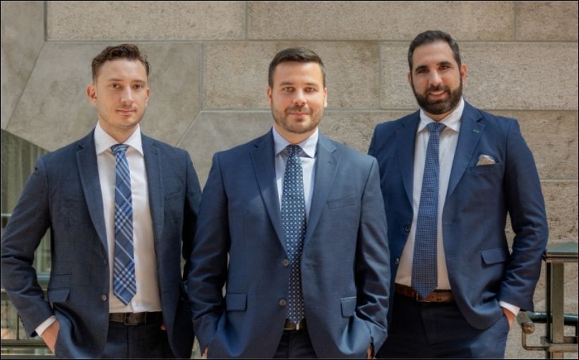 Photo of three men in suits.