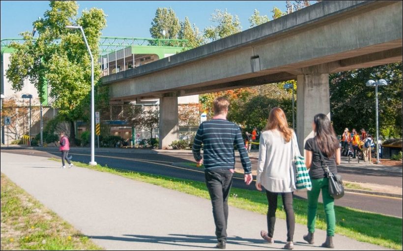 Photo of people walking near the 22nd Avenue SkyTrain station in New Westminster.