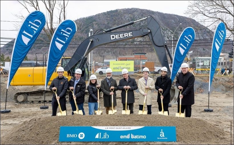 Photo people holding shovels in dirt.