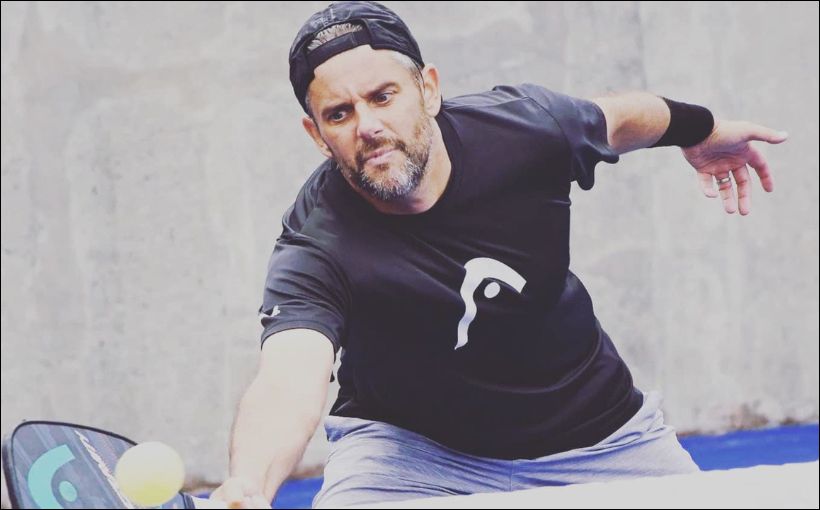 Photo of man playing pickleball.